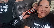Cj is registered to the contest to win money with this photo: baby, infant, family, adults, selfie, portrait, smiling, couch, leather, indoors, living_room, seated, clothing, shirt, sunglasses, socks, blanket, home, faces, casual