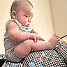 Cj is registered to the contest to win money with this photo: baby, infant, child, sitting, toes, feet, blanket, checkered_pattern, floral_pattern, gray_clothing, portrait, indoor, warm_lighting, profile, barefoot, round_face, closed_eyes, cozy, home, photography