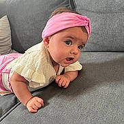Zoé participe au concours pour gagner de l'argent avec cette photo : baby, child, couch, cozy, cute, expression, face, gray_furniture, hand, headband, home, indoor, infant, person, pink_clothing, portrait, sitting, soft_light, white_sweater, young