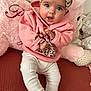 Zoé a rejoint le concours — aidez-le/la à gagner de superbes lots ! baby, child, clothing, couch, cozy, cute, head, headband, indoors, infant, leopard_print, person, pink_hoodie, plush_toy, portrait, sitting, smiling, soft_toy, textured_surface, white_pants