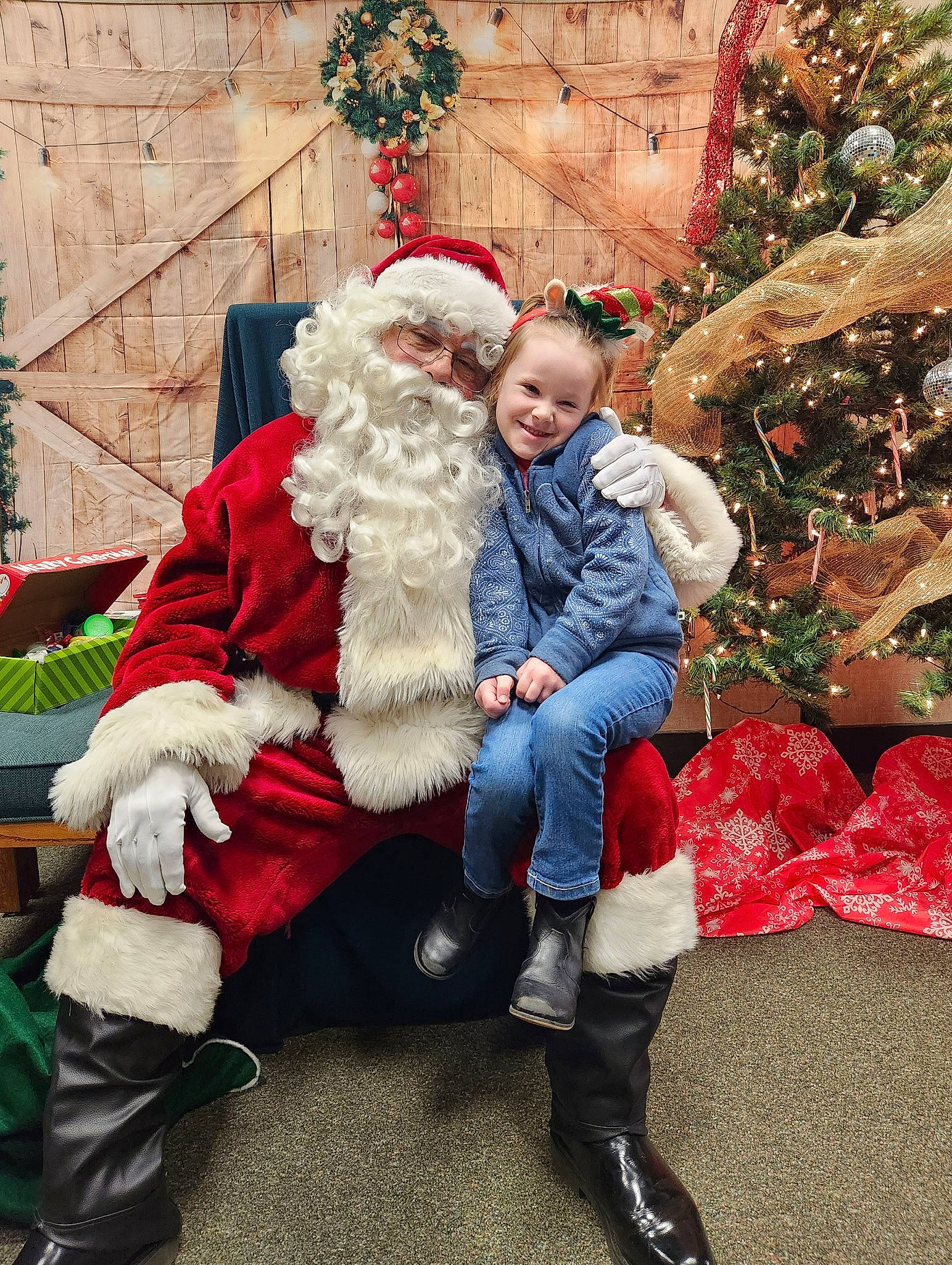 Dahlia is registered to the contest to win money with this photo: beard, christmas, christmas_decoration, christmas_eve, christmas_ornament, christmas_tree, event, fun, fur_clothing, happy, hat, holiday, human_body, joy, lap, person, plant, red, santa_claus, smile