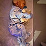baby, sleeping, pacifier, stuffed_animal, blue_pajamas, nike, blanket, infant, cozy, child, footed_pajamas, soft_toy, resting, indoors, cute, peaceful, face, head, small, lying_down
