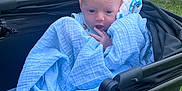 Oliver is registered to the contest to win money with this photo: baby, blanket, stroller, outdoor, greenery, path, infant, cute, child, person, blue, clothing, nature, grass, young, face, hand, sitting, cozy, portrait