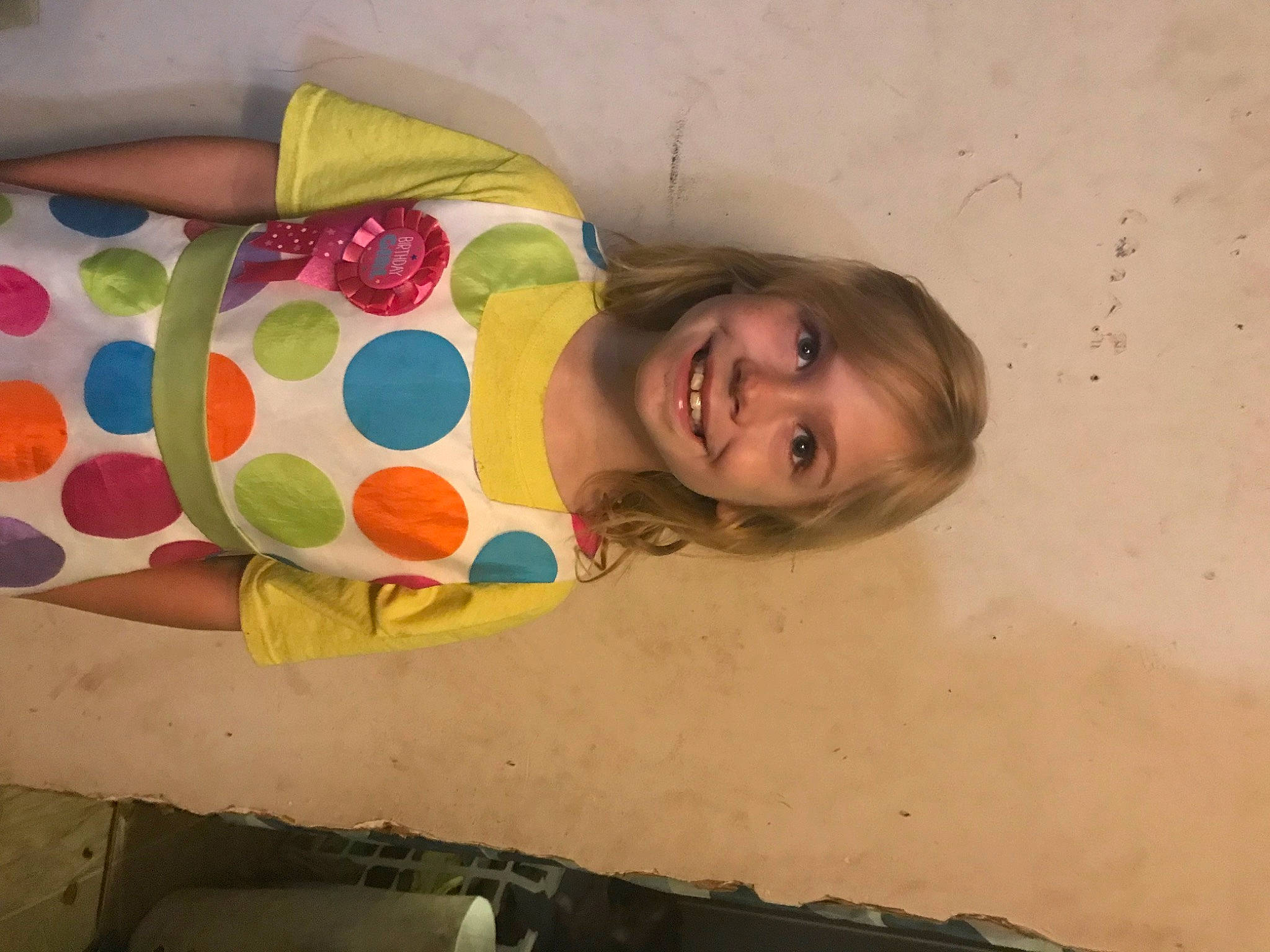 Charleigh is registered to the contest to win money with this photo: arm, cheek, child, comfort, eye, face, flooring, fun, hair, happy, head, human_body, joy, linens, mouth, pattern, person, room, sitting, skin