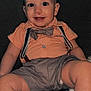 Damon joined the competition — help win amazing prizes! baby, child, smile, face, bow_tie, suspenders, shirt, shorts, couch, furniture, indoors, cute, happy, portrait, person, legs, seated, infant, clothing, young