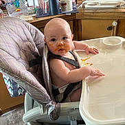 Hailee joined the competition — help win amazing prizes! baby, high_chair, messy_face, food, kitchen, cup, utensils, diaper, child, infant, plastic_tray, wood_cabinet, curious, straps, feeding, mess, tabletop, indoor, person, cute