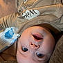 Hailee joined the competition — help win amazing prizes! baby, infant, face, onesie, cartoon, clothing, couch, upside_down, wide_eyes, mouth_open, soft_furniture, baby_wipes, indoor, close_up, cute, child, person, happy, expression, skin