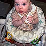 Hailee is registered to the contest to win money with this photo: baby, infant, child, bib, highchair, toy, rings, pattern, clothing, expression, face, hands, legs, feet, indoor, curious, seat, closeup, cute, drool