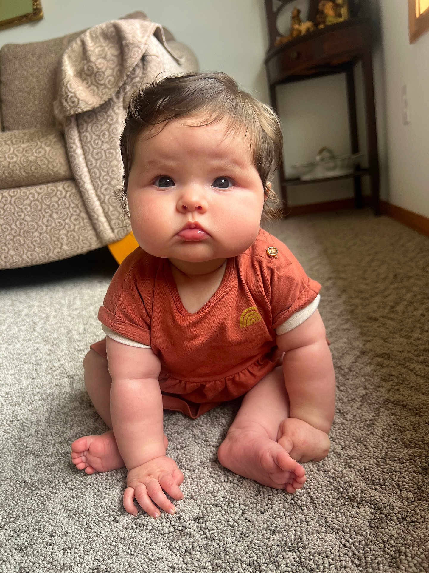 Iyla is registered to the contest to win money with this photo: baby, child, infant, carpet, floor, indoor, furniture, chair, table, clothing, person, cute, expression, sitting, skin, hand, foot, hair, room, window