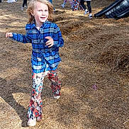 Katerina is registered to the contest to win money with this photo: activity, autumn, blue_plaid_shirt, casual_clothing, child, colorful_pants, daylight, event, family, fun, grass, hay, leaves, nature, outdoor, people, playful, running, smile, trees