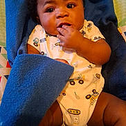 Ceejay is registered to the contest to win money with this photo: baby, blanket, blue, child, clothing, cute, expression, face, fingers, indoor, infant, laying, onesie, person, portrait, skin, toddler, young, young_child, curious