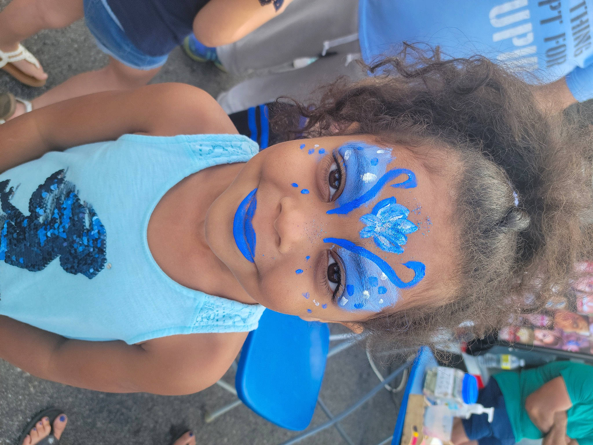 Oriana is registered to the contest to win money with this photo: abdomen, blue, chest, child, electric_blue, event, eye, eyelash, eyewear, fan, flesh, fun, happy, hat, human_leg, joy, leisure, mouth, person, public_event