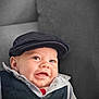 baby, smiling, face, hat, vest, shirt, infant, child, cute, portrait, indoors, couch, clothing, headwear, happy, young, person, sitting, comfortable, casual