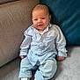 baby, infant, smile, couch, blue_cushion, striped_shirt, jeans, white_socks, rolled_jeans, happy, indoor, cute, child, person, portrait, seated, cozy, comfortable, fabric, home