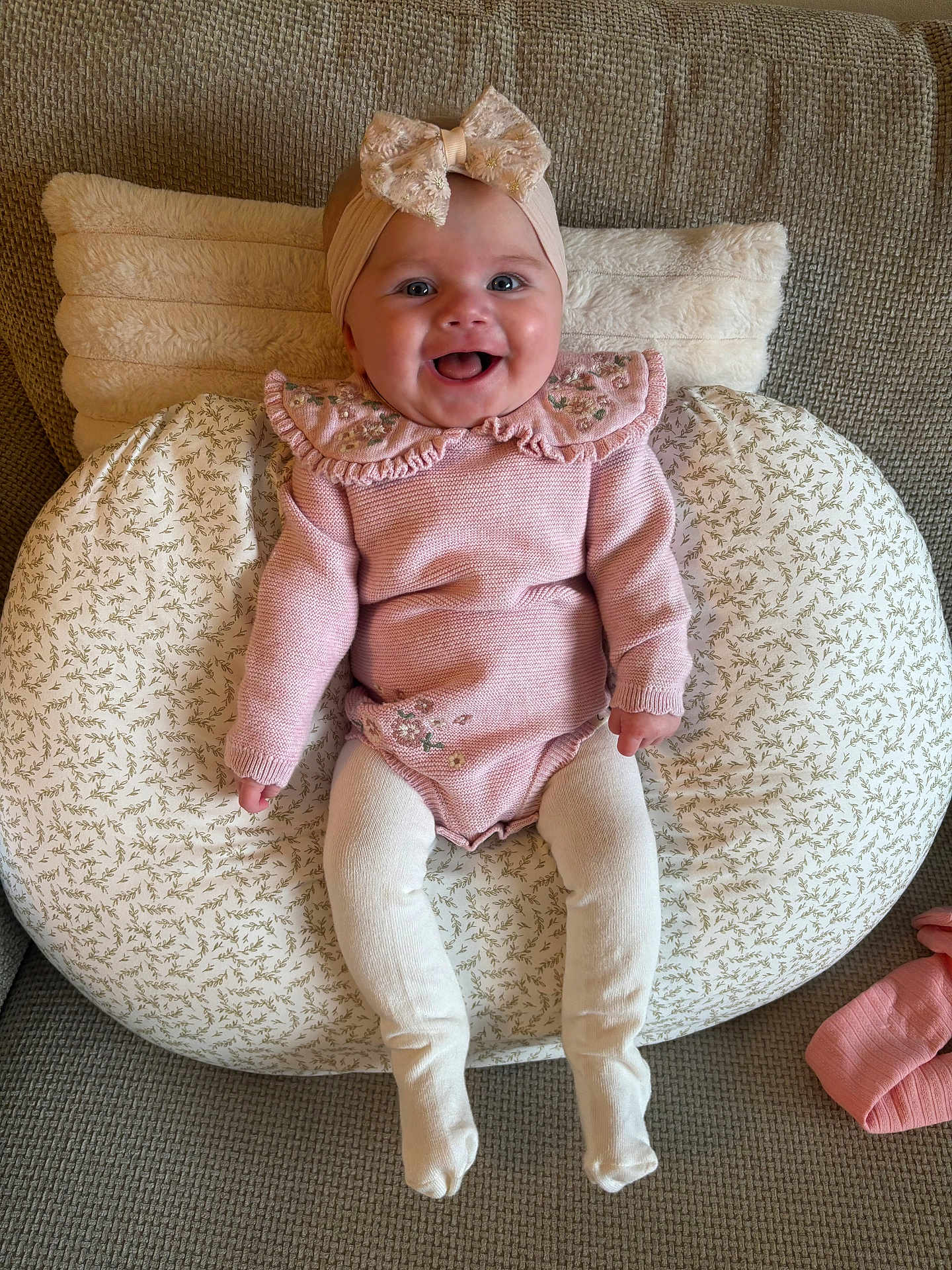 Nevah joined the competition — help win amazing prizes! apparel, baby, bow, child, cozy, cushion, cute, happy, headband, indoor, infant, knitted, patterned_cushion, pink_clothing, portrait, seated, smiling, sofa, tights, young_child