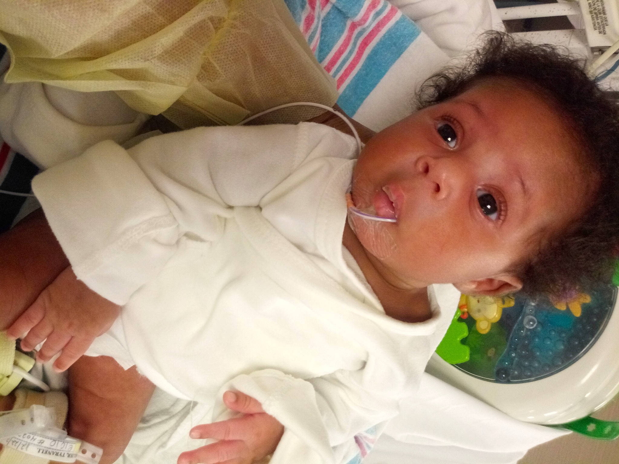 Chozyn is registered to the contest to win money with this photo: baby, baby_toddler_clothing, cheek, child, comfort, dishware, drinkware, eyelash, finger, happy, head, iris, linens, lip, nose, person, skin, sleeve, tableware, textile