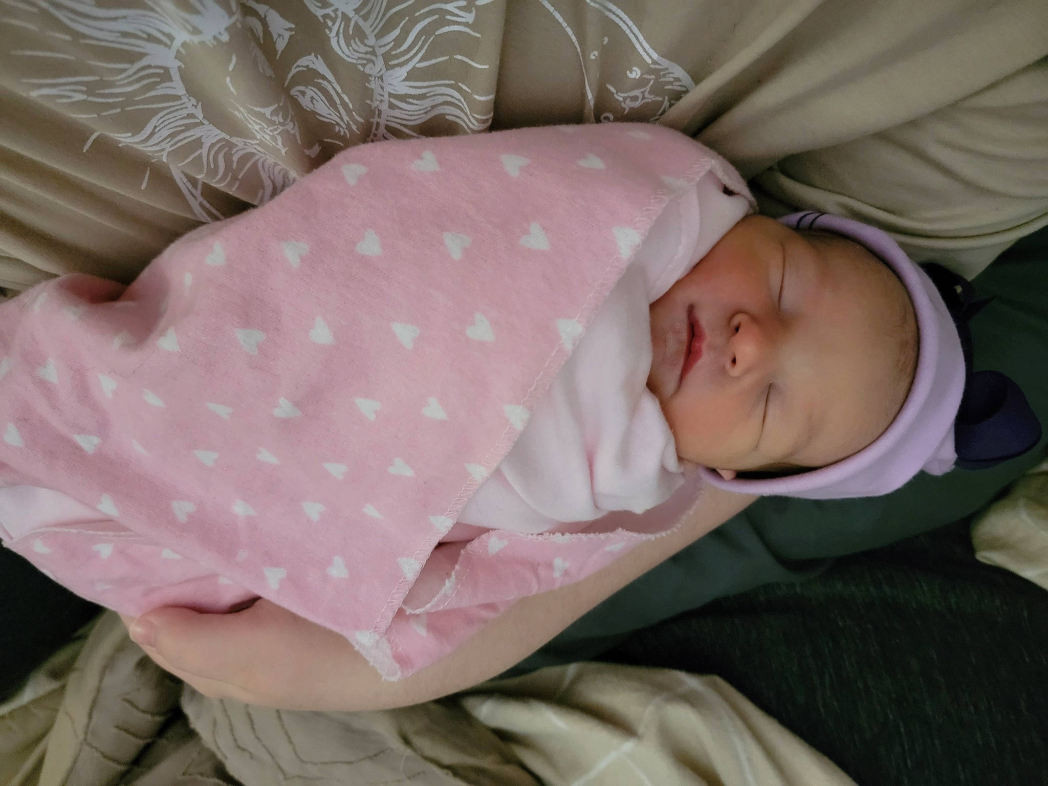 Judy is registered to the contest to win money with this photo: baby, baby_products, baby_sleeping, baby_toddler_clothing, cheek, child, comfort, hat, linens, mammal, nap, pattern, person, pink, product, room, skin, sleep, sleeve, toddler