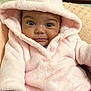 baby, infant, pink_hoodie, bear_ears, polka_dot_pants, bracelet, cute, soft_texture, blanket, smiling, indoors, child, portrait, cozy, warm_clothing, young_child, comfortable, seated, apparel, happy