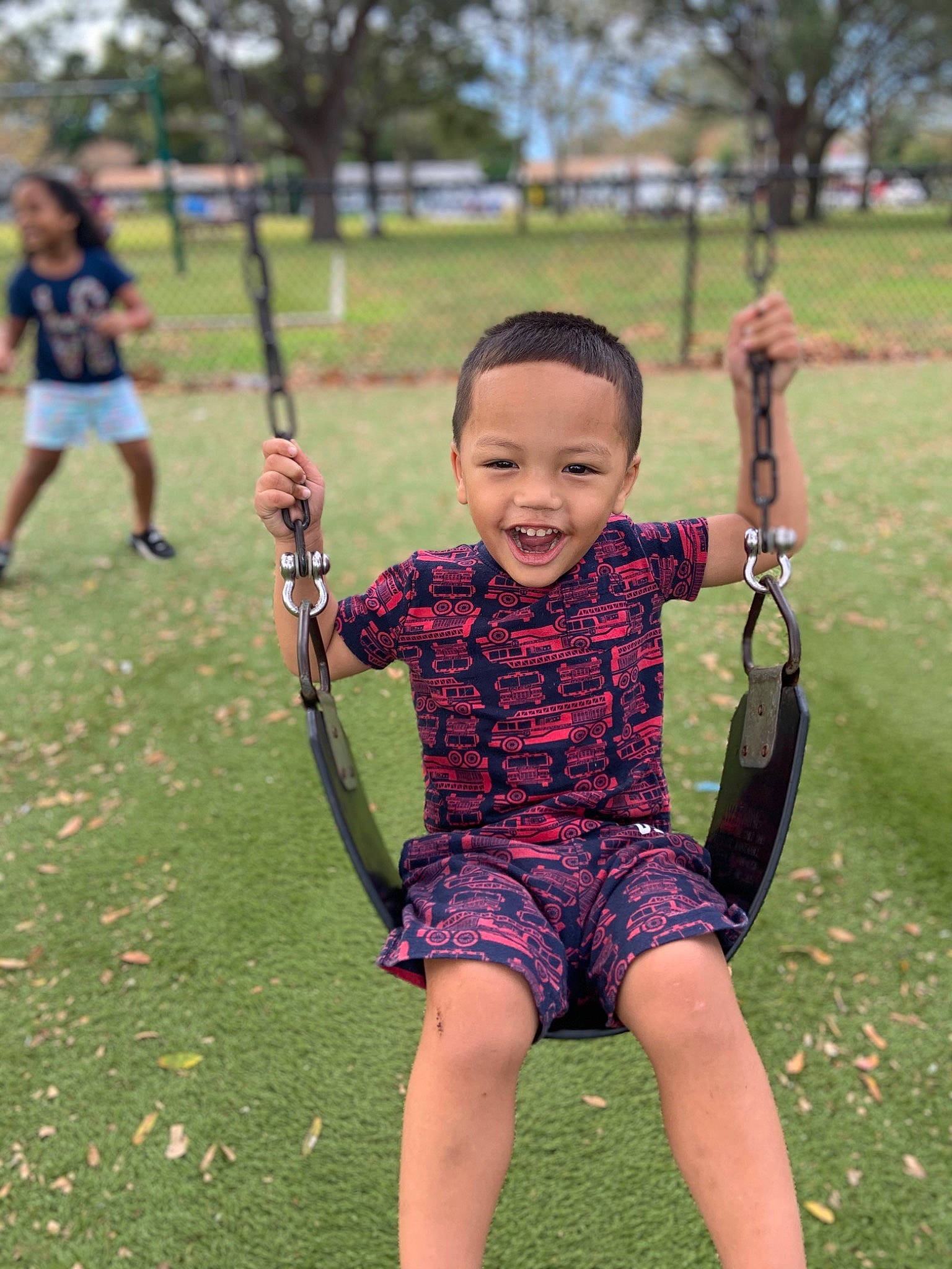 Tony Jr joined the competition — help win amazing prizes! barefoot, city, electric_blue, fun, grass, grassland, happy, human_body, human_settlement, joy, leisure, people_in_nature, person, plant, public_space, recreation, shorts, smile, summer, swing