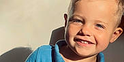 Nolan participe au concours pour gagner de l'argent avec cette photo : child, boy, smile, happy, blue_shirt, polo_shirt, short_sleeves, sunlight, shadow, portrait, indoor, face, hair, young_child, casual_clothing, closeup, light, skin, cute, person