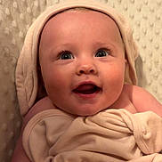 Josephine joined the competition — help win amazing prizes! baby, blanket, child, closeup, cozy, cute, expression, face, happy, hooded_towel, indoors, infant, newborn, portrait, skin, smiling, soft_texture, towel, warm, wrapped