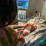 newborn, hospital, medical_equipment, incubator, monitor, tattoo, adult, hand, infant, patient, cables, bed, healthcare, care, person, tubes, nursery, premature_baby, life_support, clinic