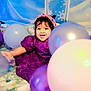 toddler, child, balloons, purple_dress, flower_headband, smiling, celebration, birthday, number_one, blue_backdrop, snowflakes, happy, indoors, festive, colorful, party, young_child, cute, joyful, portrait
