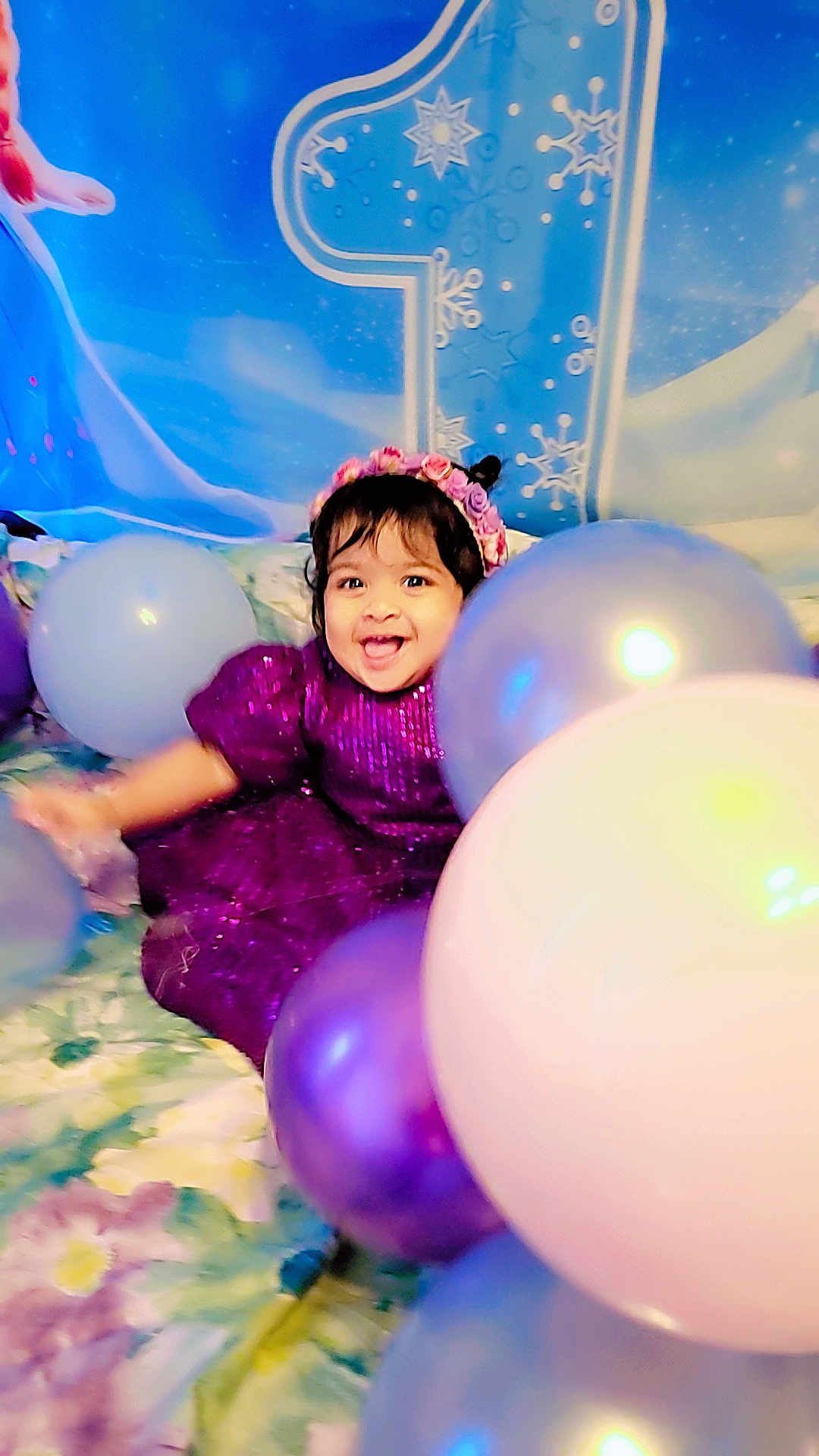 Rainelle joined the competition — help win amazing prizes! toddler, child, balloons, purple_dress, flower_headband, smiling, celebration, birthday, number_one, blue_backdrop, snowflakes, happy, indoors, festive, colorful, party, young_child, cute, joyful, portrait