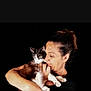 Fripon participe au concours pour gagner de l'argent avec cette photo : woman, cat, pet, animal, black_background, portrait, affection, holding, love, domestic_animal, feline, human, face, earring, casual_clothing, indoor, closeup, expression, comfort, cuddle