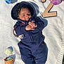 Santana joined the competition — help win amazing prizes! baby, child, hoodie, pants, blanket, plush_toys, number_two, wooden_number, ice_cream_cone, pacifier, outdoor, grass, sunlight, smiling, cute, infant, white_socks, toy, relaxing, portrait