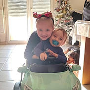 Liam participe au concours pour gagner de l'argent avec cette photo : baby, chair, child, christmas_tree, cute, dog, family, floor_tiles, happy, holiday_decorations, indoor, pacifier, play, reindeer_antlers, smiling, sunlight, table, toddler, toy_car, window