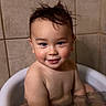 Eli is registered to the contest to win money with this photo: toddler, child, bath, water, smile, wet_hair, face, skin, bathtub, sitting, happy, indoors, cute, person, head, portrait, young_child, tile_wall, baby, playful