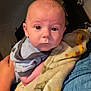 Nolan joined the competition — help win amazing prizes! baby, infant, blanket, person, face, indoor, holding, clothing, curious, soft, closeup, head, human, toddler, warm, expression, looking, young, caring, portrait