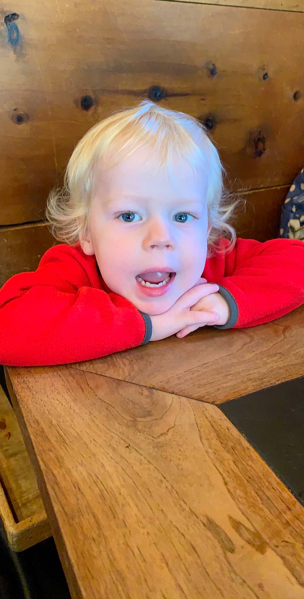 Noah is registered to the contest to win money with this photo: baby, blond, cheek, child, chin, face, head, lip, mouth, nose, person, play, skin, smile, surprise, toddler, wood