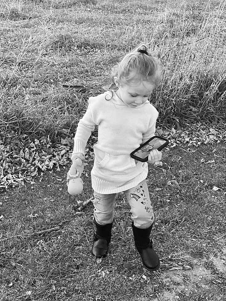 Aubrianna is registered to the contest to win money with this photo: arm, black_and_white, gesture, grass, grass_family, grassland, hand, happy, landscape, leaf, meadow, monochrome, monochrome_photography, nature, people_in_nature, person, plant, shorts, smile, standing