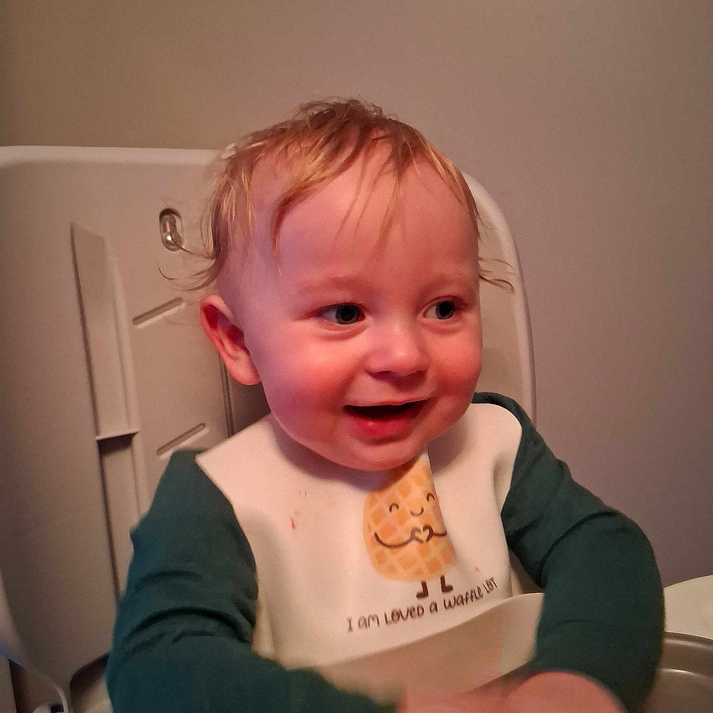 Onyx is registered to the contest to win money with this photo: baby, bib, blond_hair, child, clothing, cute, expression, face, feeding, happy, high_chair, indoor, messy_hair, person, portrait, sitting, smiling, table, toddler, young