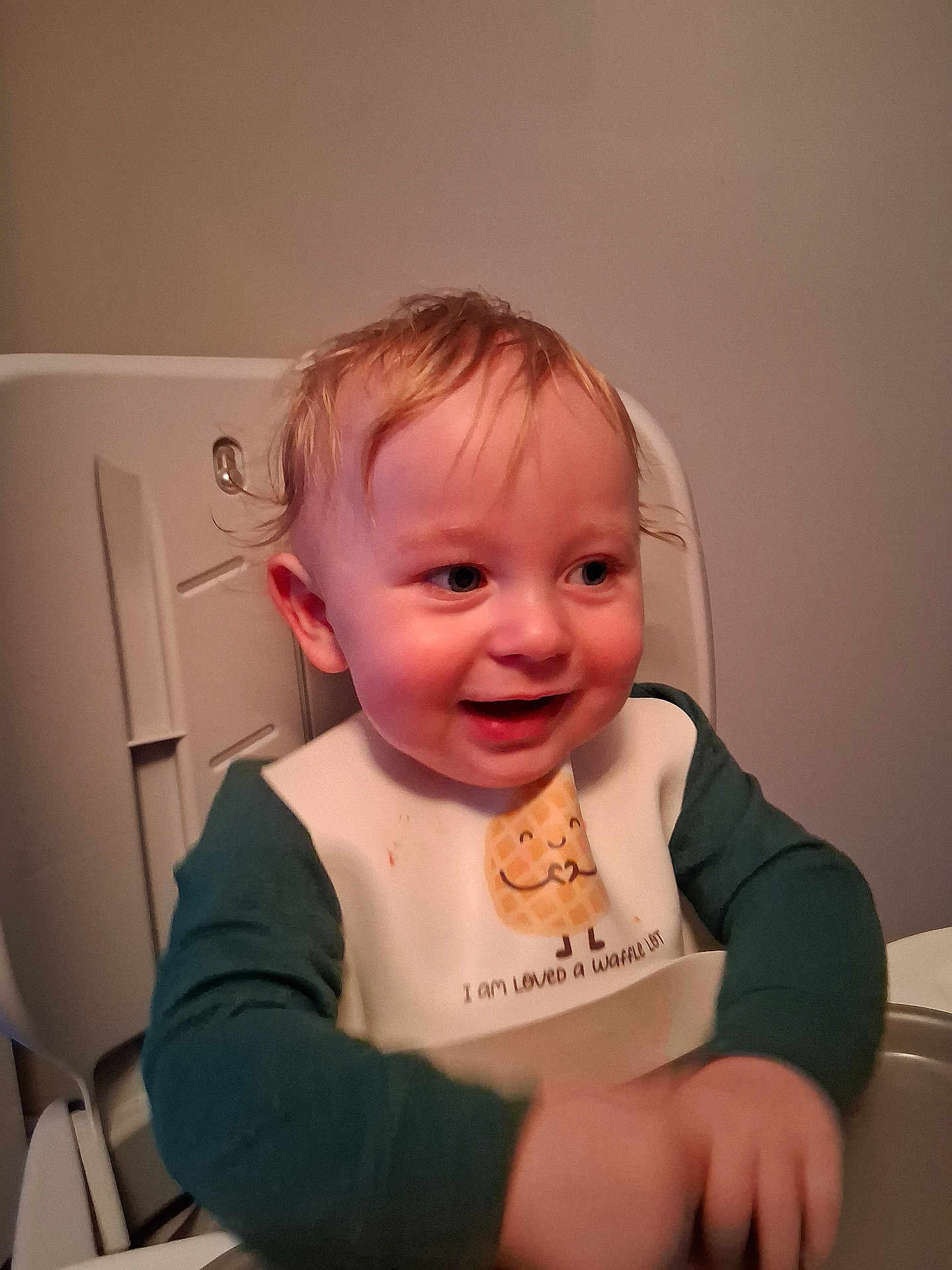 Onyx is registered to the contest to win money with this photo: baby, bib, blond_hair, child, clothing, cute, expression, face, feeding, happy, high_chair, indoor, messy_hair, person, portrait, sitting, smiling, table, toddler, young