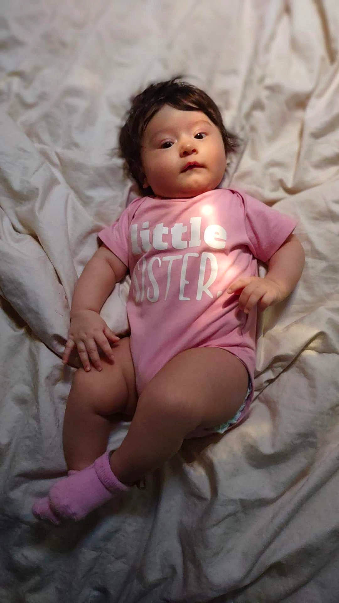 Artemis is registered to the contest to win money with this photo: baby, bed, bedroom, bodypart, clothing, cushion, face, furniture, head, homedecor, indoors, newborn, person, photography, portrait, room, shorts, sitting, sleeping, t_shirt