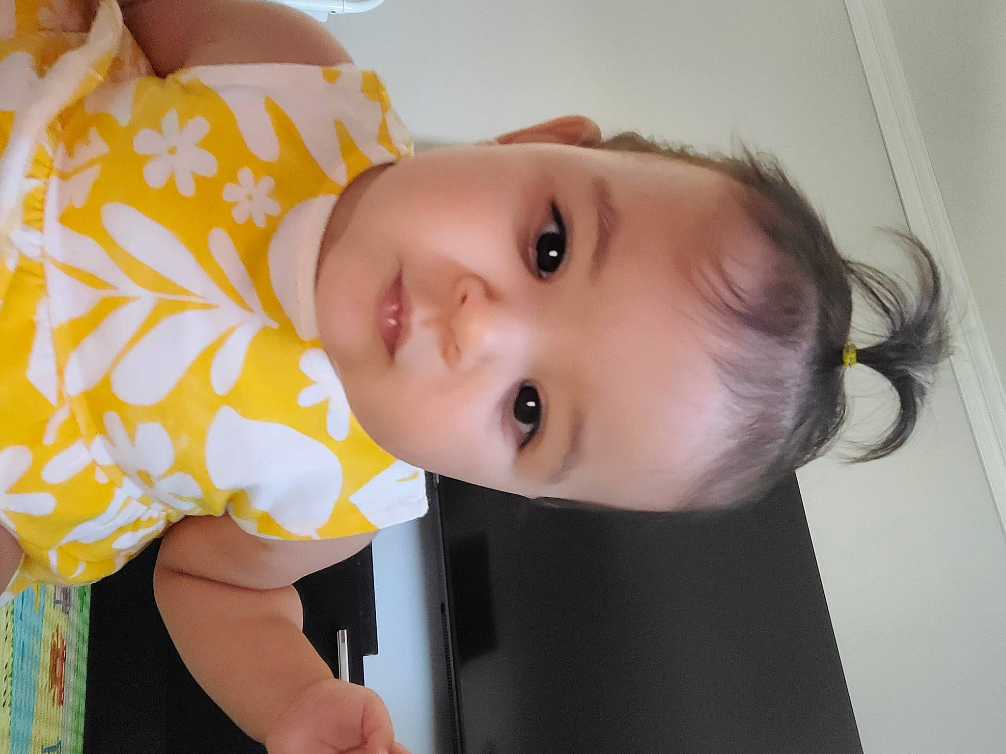 Talya participe au concours pour gagner de l'argent avec cette photo : baby, baby_products, baby_toddler_clothing, cheek, child, eyelash, facial_expression, fun, happy, iris, lip, neck, nose, pattern, person, room, skin, sleeve, toddler, wood