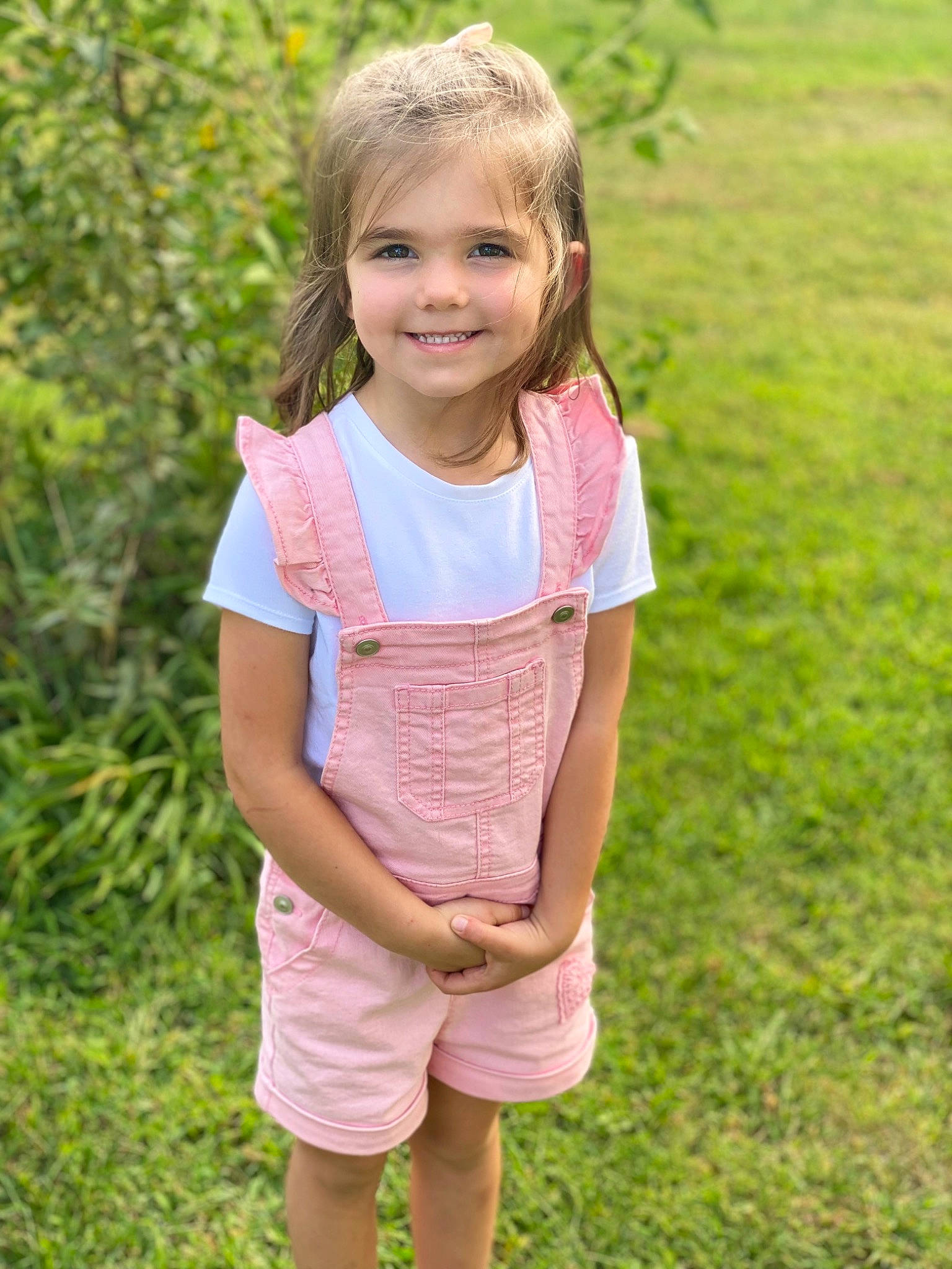 Jaelynn is registered to the contest to win money with this photo: baby_toddler_clothing, eye, gesture, grass, grass_family, grassland, hair, hand, happy, human_body, joy, meadow, nature, people_in_nature, person, plant, skin, sleeve, smile, t_shirt