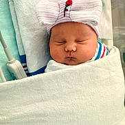Evelyn is registered to the contest to win money with this photo: newborn, baby, infant, sleeping, portrait, face, hospital, blanket, swaddled, hat, bow, striped, indoors, bedding, peaceful, closed_eyes, nursery, medical_equipment, photography, resting