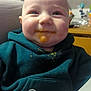 baby, child, messy_face, smiling, hoodie, food, baby_food, high_chair, indoor, closeup, happy, face, clothing, seatbelt, feeding, infant, cute, portrait, chubby_cheeks, dining