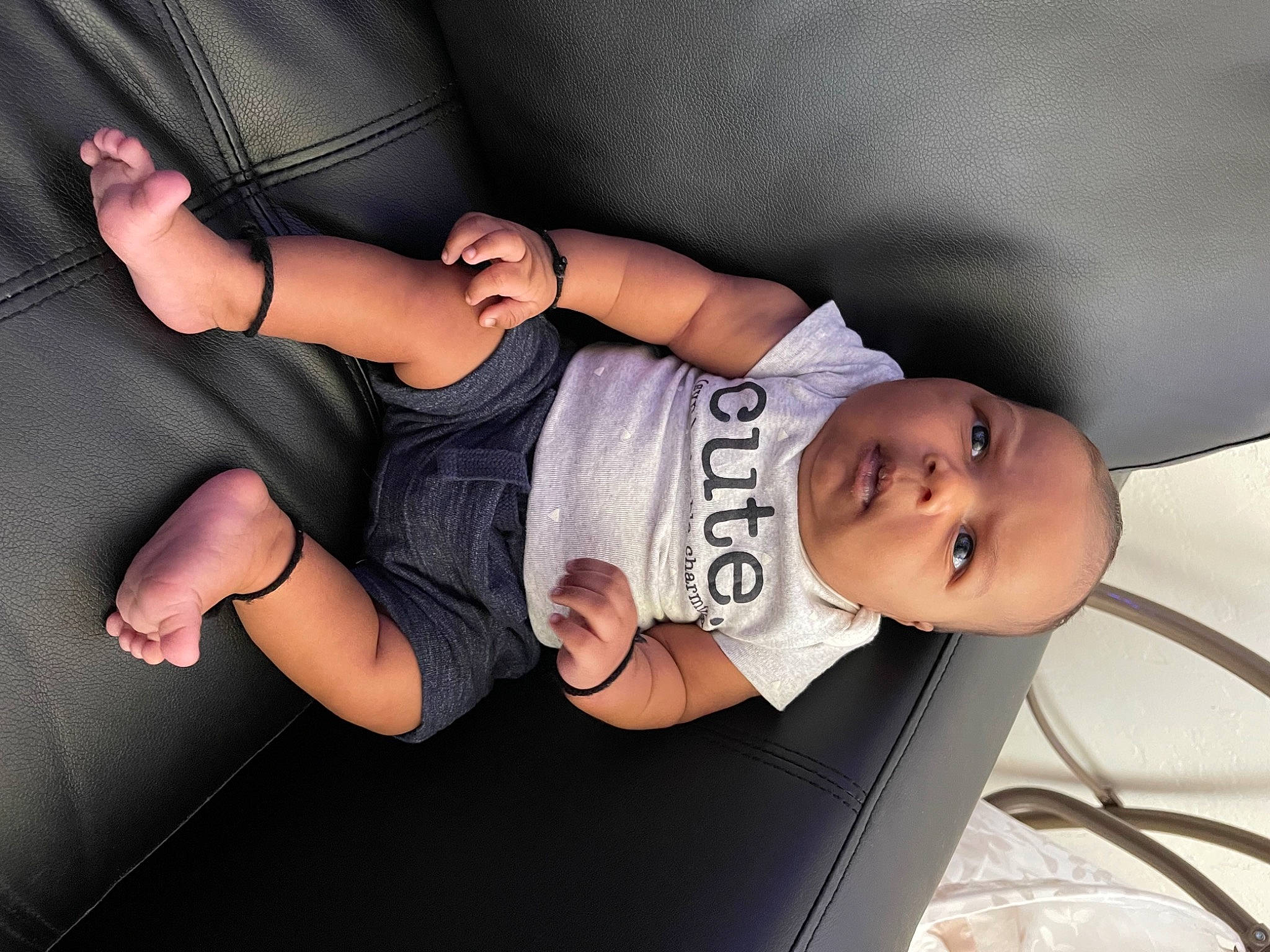 Amani is registered to the contest to win money with this photo: arm, auto_part, car_seat, comfort, elbow, finger, flash_photography, gesture, hand, headgear, human_body, human_leg, joint, knee, leg, mouth, neck, person, sleeve, t_shirt