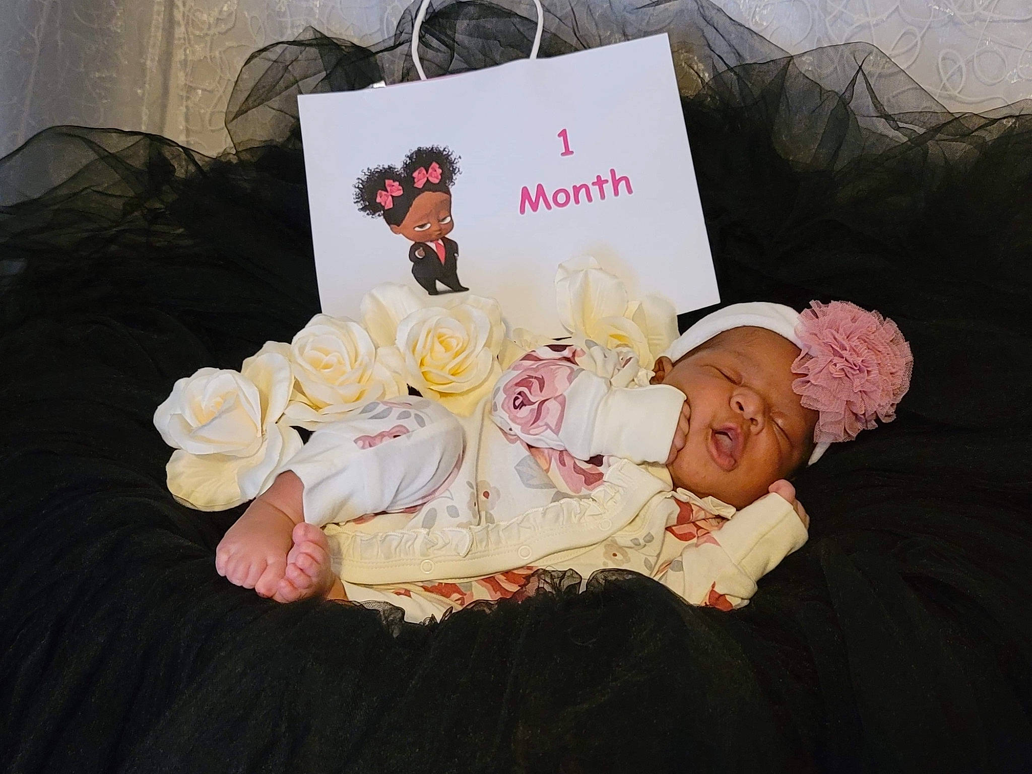 Gianna is registered to the contest to win money with this photo: baby, child, cut_flowers, fashion_accessory, flower, furniture, hair_accessory, happy, headgear, headpiece, illustration, linens, person, pink, plant, rose, rose_family, t_shirt, textile