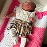 baby, blanket, child, clothing, cozy, crochet, cute, indoors, infant, lace, lying_down, newborn, person, pink, plaid, portrait, small, socks, soft, white