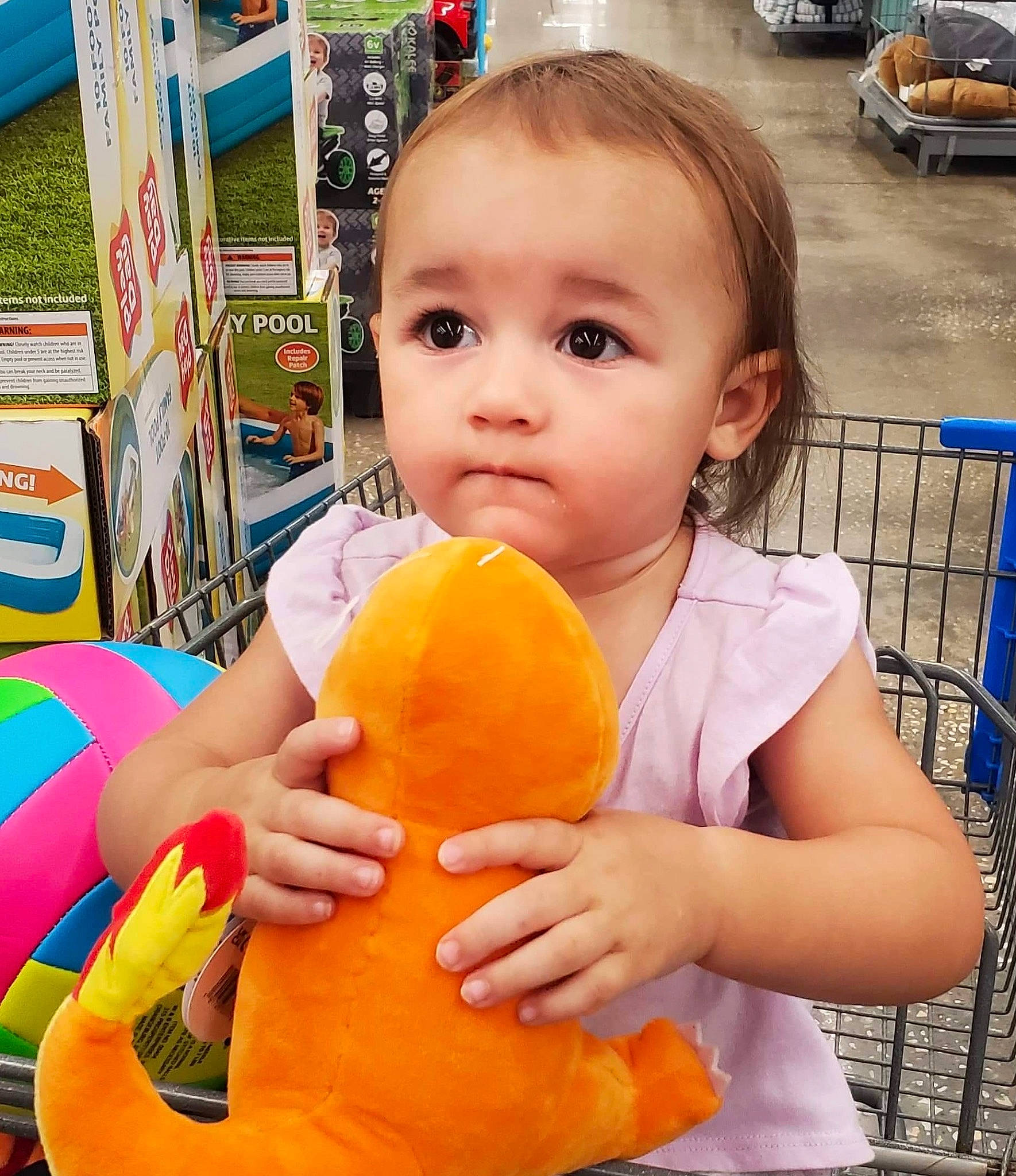 Gracie is registered to the contest to win money with this photo: baby, baby_playing_with_toys, beauty, child, fun, gesture, hand, happy, leisure, nose, orange, people, person, photograph, product, public_space, skin, summer, toddler, trunk