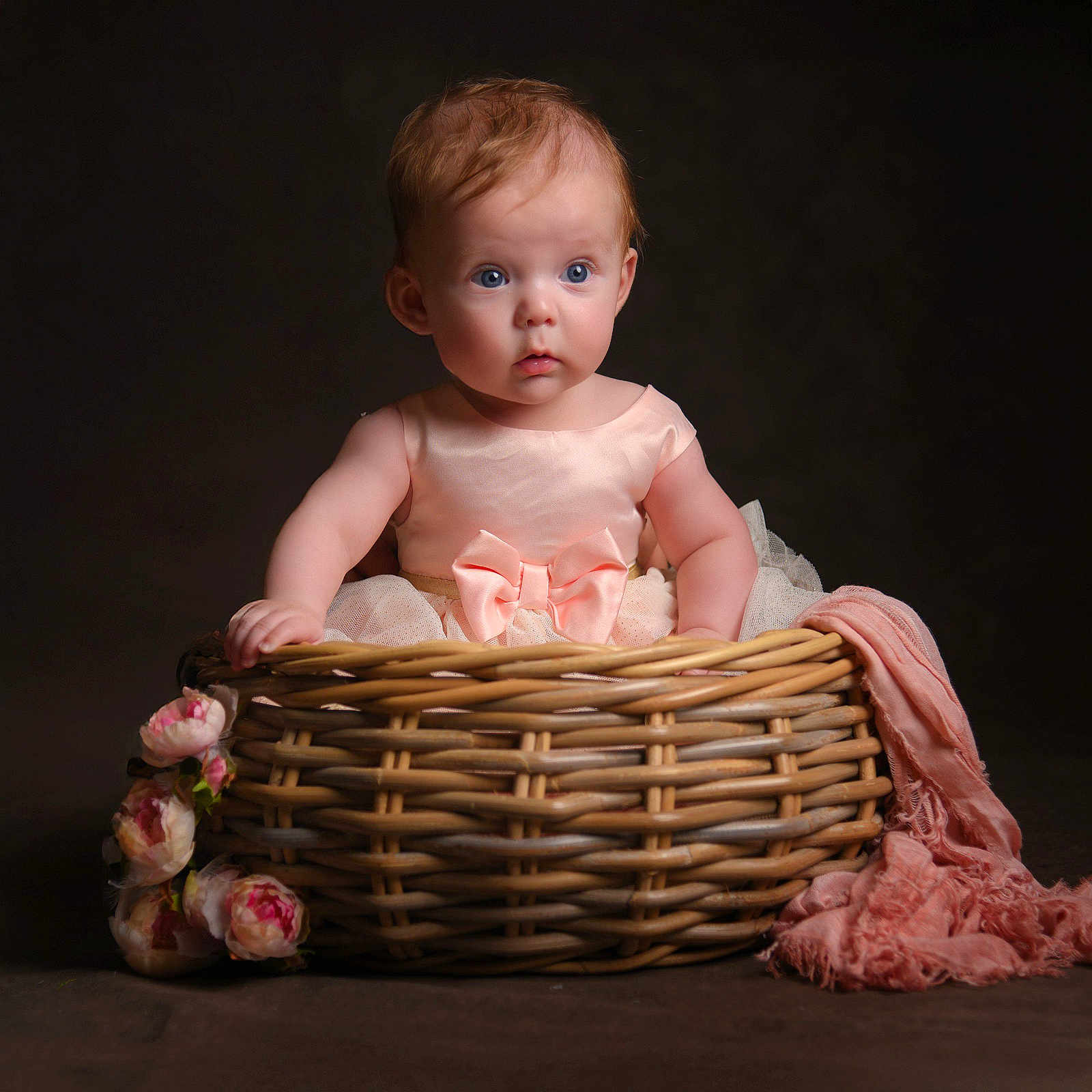 Lylah is registered to the contest to win money with this photo: baby, infant, child, basket, pink_dress, bow, flowers, scarf, portrait, studio, adorable, cute, wide_eyes, soft_lighting, sitting, woven_basket, pink, skin, expression, background