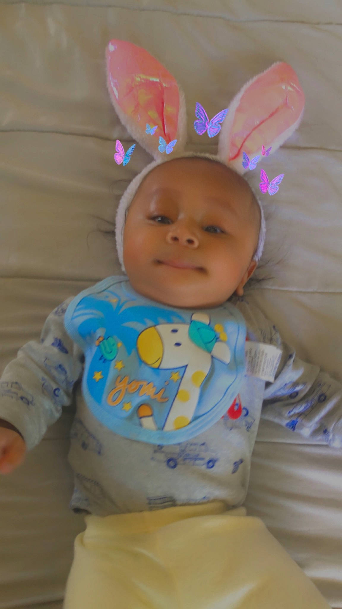 Issac is registered to the contest to win money with this photo: baby, baby_toddler_clothing, bib, cheek, chin, ear, eye, eyebrow, face, happy, head, human_body, iris, linens, nose, person, pink, skin, sleeve, smile