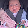baby, smiling, car_seat, toy, mirror, plush_toy, pink_blanket, white_clothing, happy, child, infant, seatbelt, colorful, hand, face, closeup, indoors, cute, soft_texture, joy
