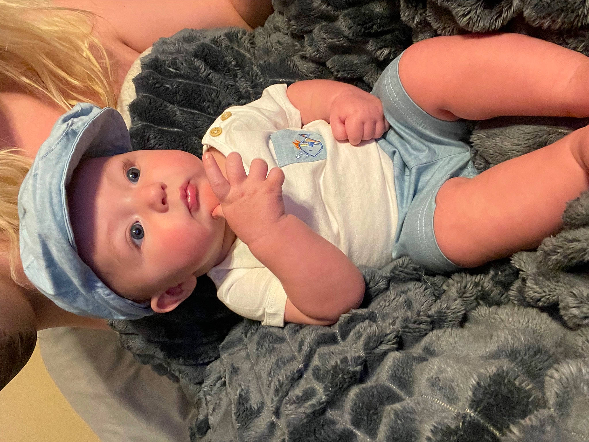 Nash is registered to the contest to win money with this photo: abdomen, baby, baby_toddler_clothing, chest, child, comfort, eyelash, grass, happy, hat, headwear, human_leg, joint, linens, nap, pattern, person, portrait_photography, sitting, sleep